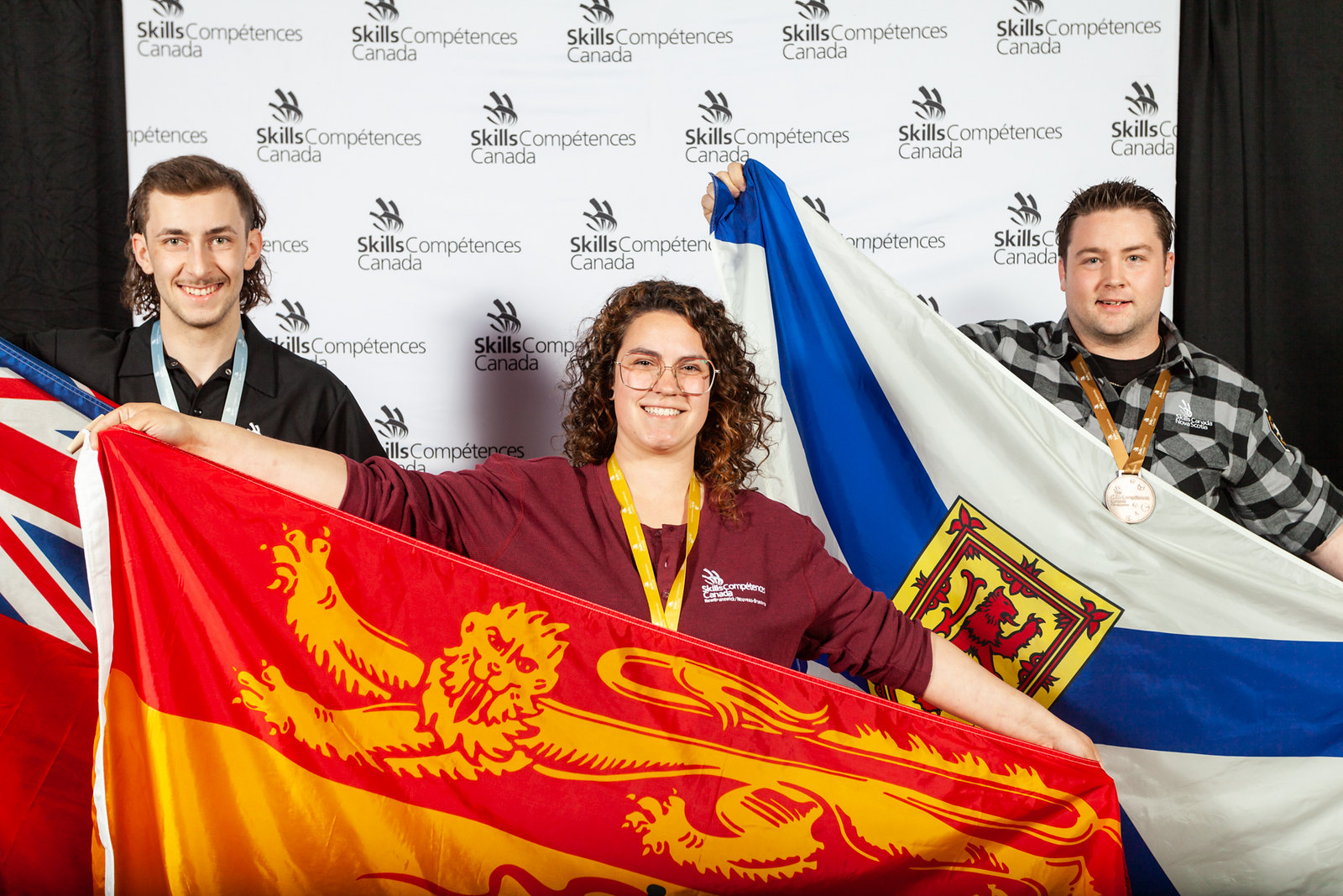 AVƷ apprentice Alice Michaud, centre, won gold in the Car Painting competition at Skills Canada nationals. Michaud also won Best in Region for New Brunswick. 